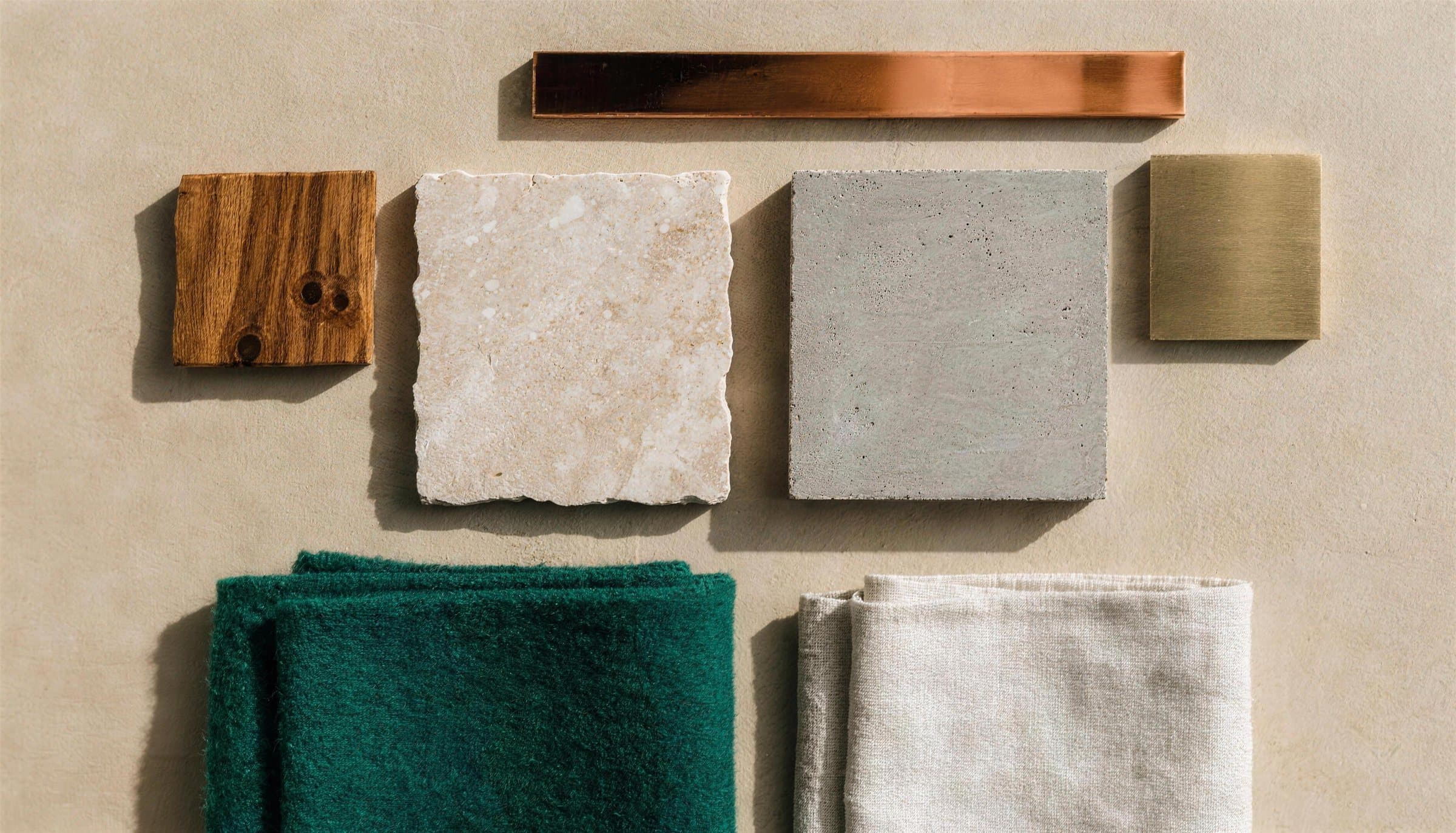 Materialprover: trä, travertin, betong, koppar, mässing, grön ull och linne